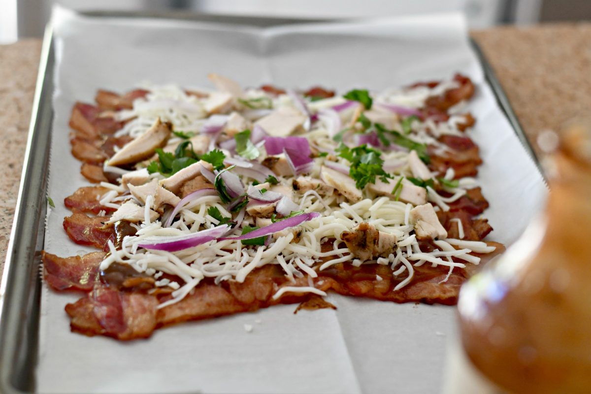 Keto BBQ Chicken Bacon Weave Pizza – topping the cooked bacon with ingredients