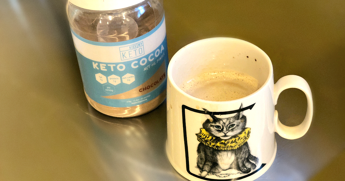 Kiss my Keto Cocoa Powder in a mug of coffee