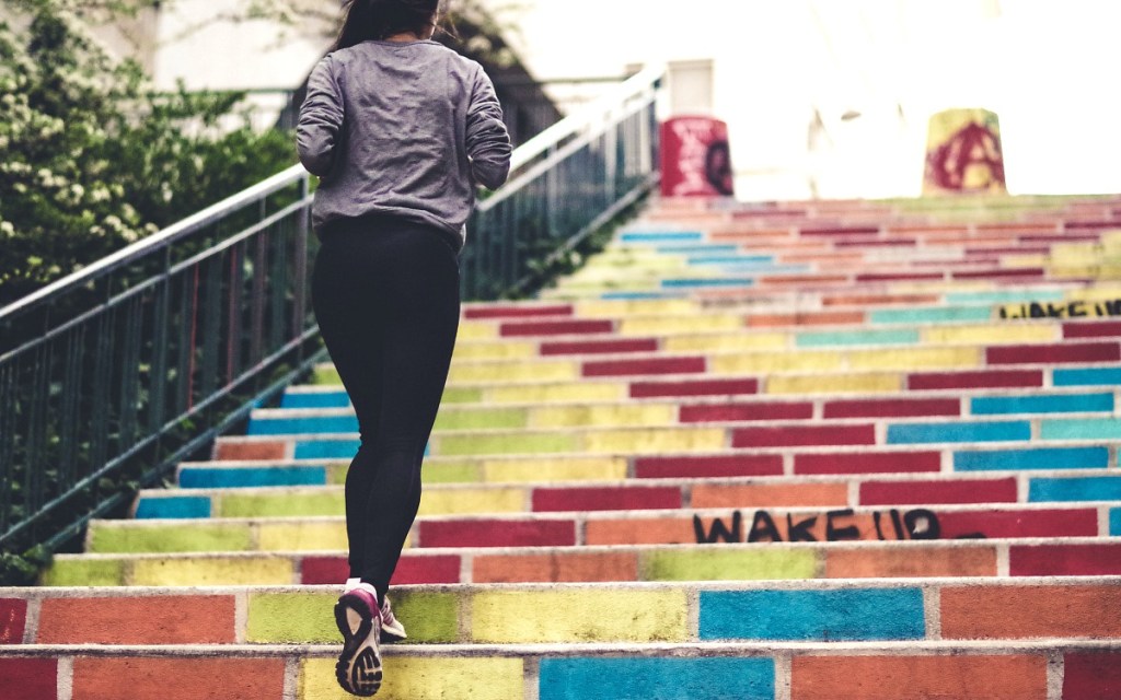 keto and exercise — woman running up stairs with endurance