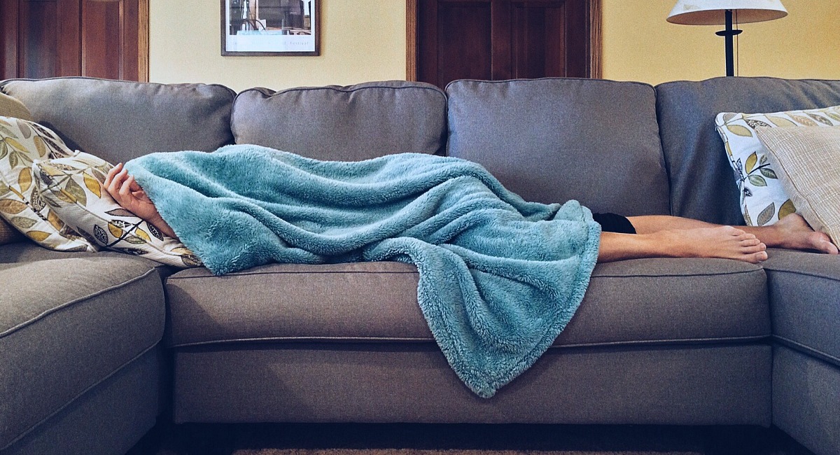 fatigued, tired person sleeping on couch