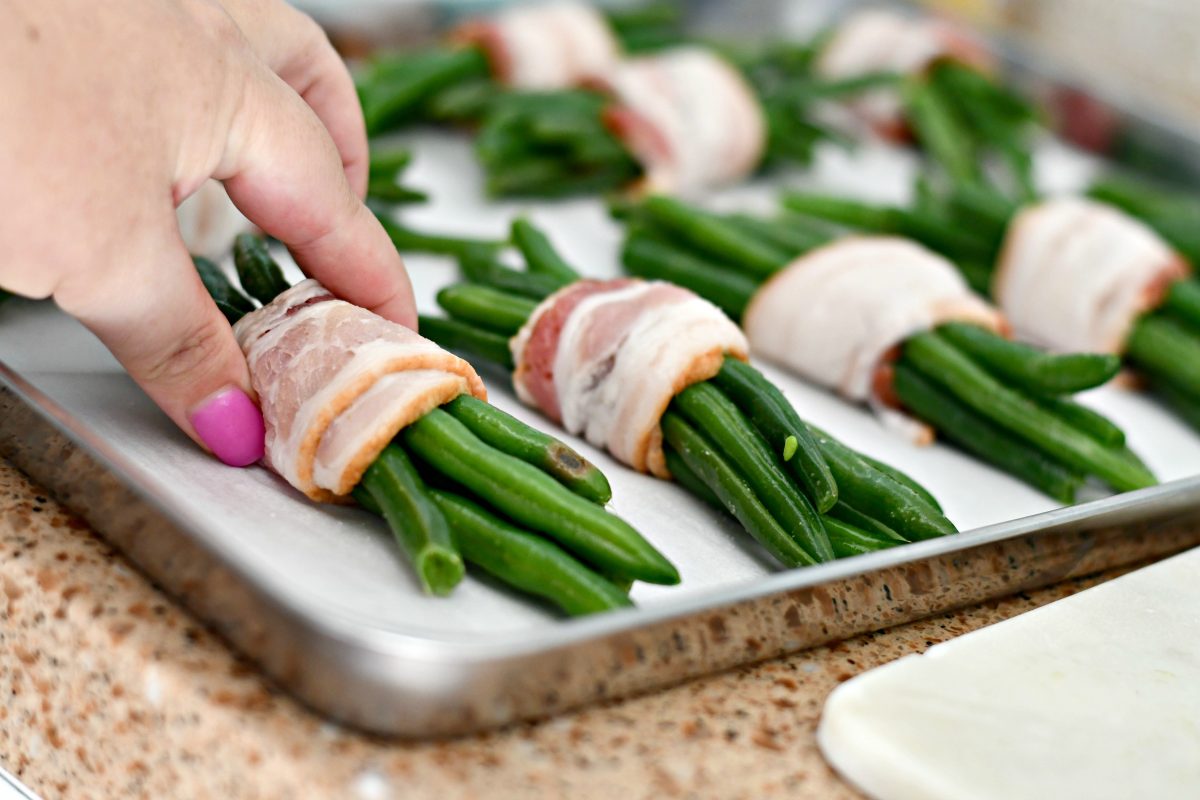 Keto Bacon Wrapped Green Bean Bundles – arranging on a baking pan