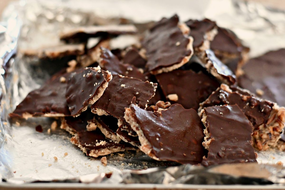 Keto "Christmas Crack" Pecan Toffee closeup on the pan after breaking it up