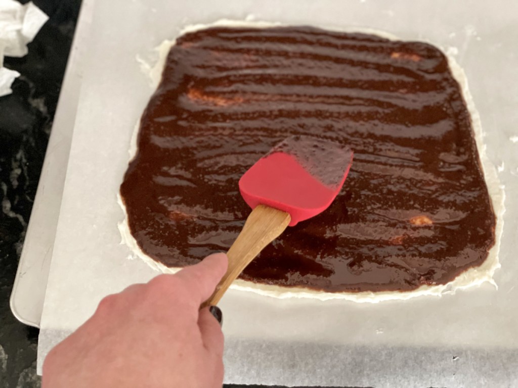 spreading chocolate for Keto Chocolate Bark