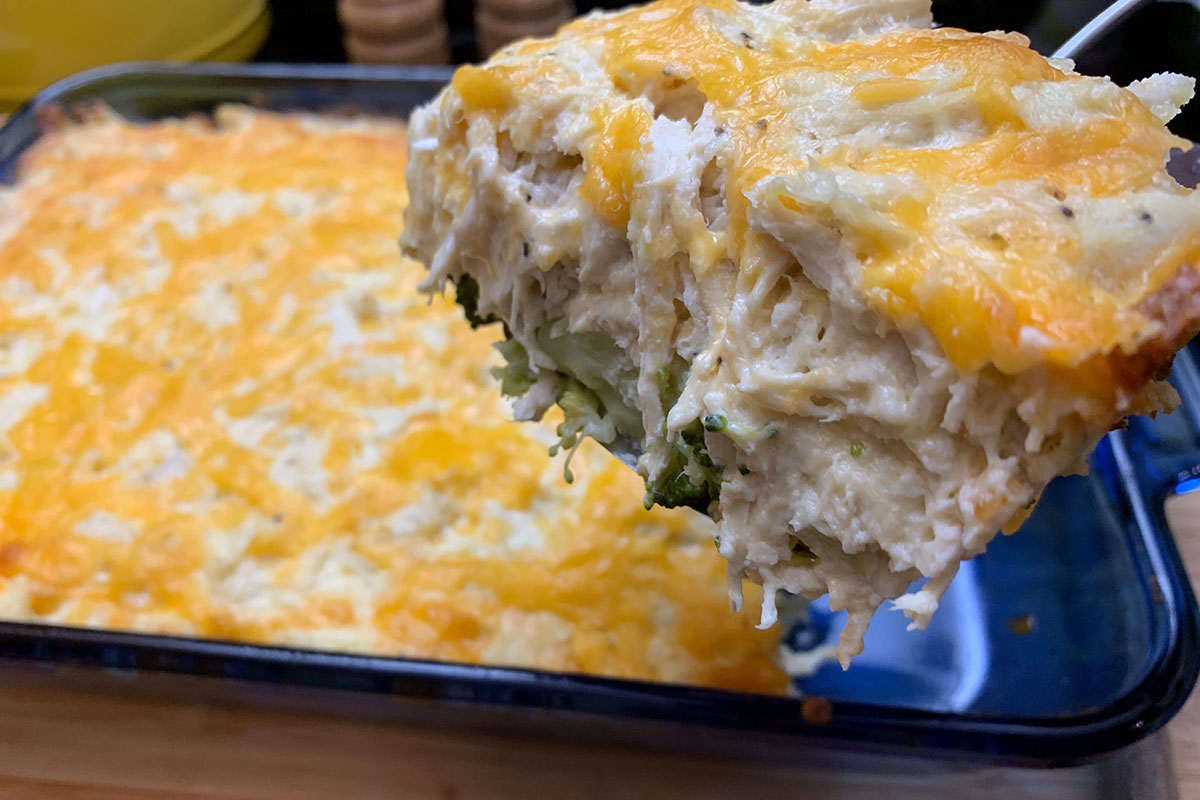 Low Carb Cheesy Chicken Casserole - a large serving of chicken casserole being scooped from a pan