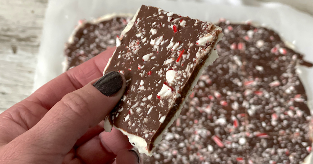 holding piece of keto chocolate peppermint bark 