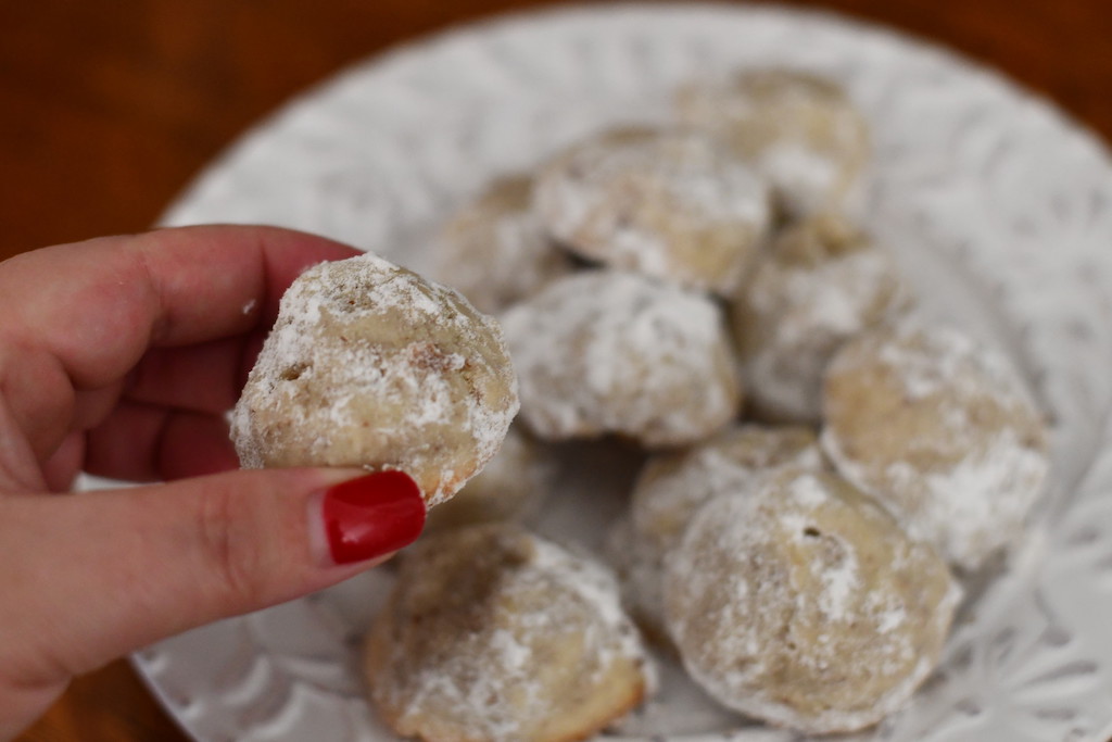 holding keto snowball cookie