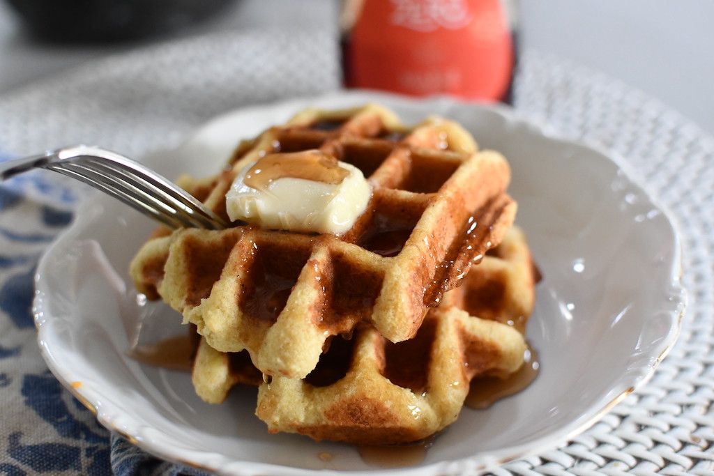eating keto waffles with maple syrup and butter