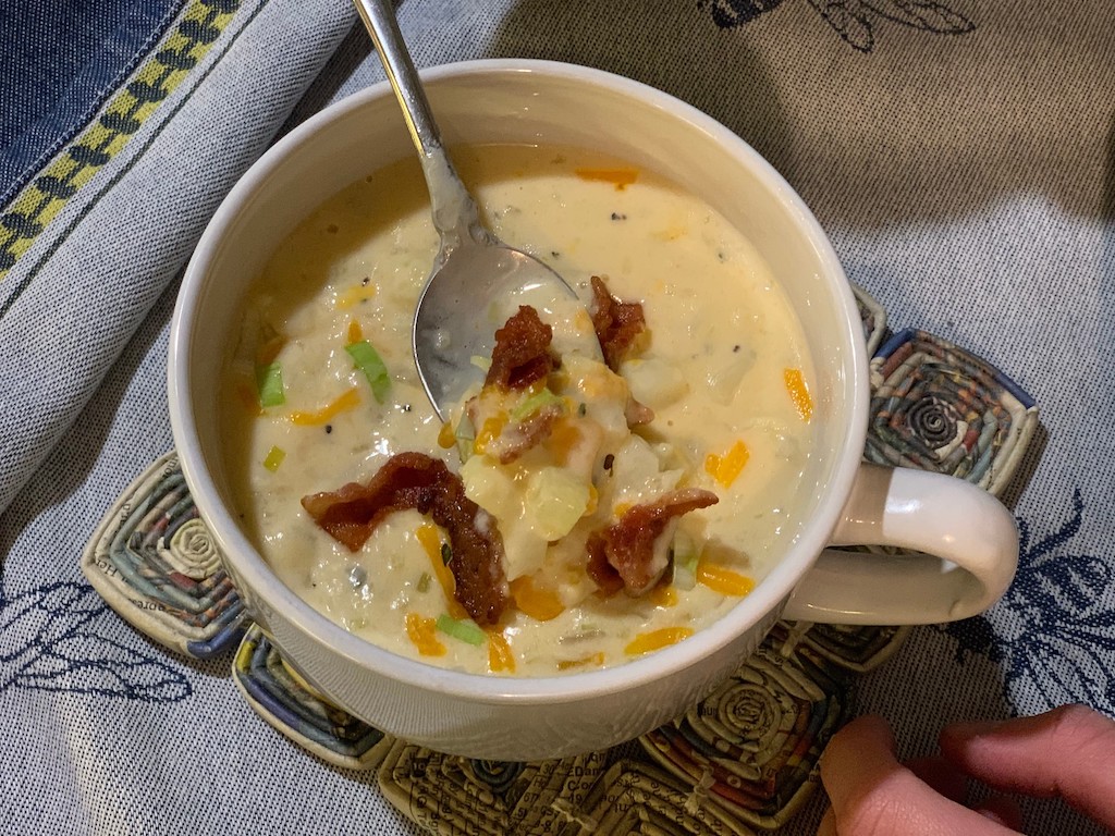 spoon scooping up creamy keto cauliflower chowder