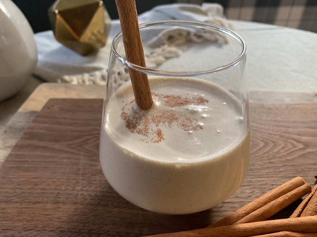 keto eggnog in glass with cinnamon stick