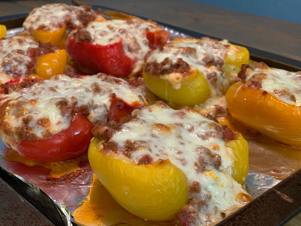 keto lasagna bell pepper boats on pan with melted cheese 