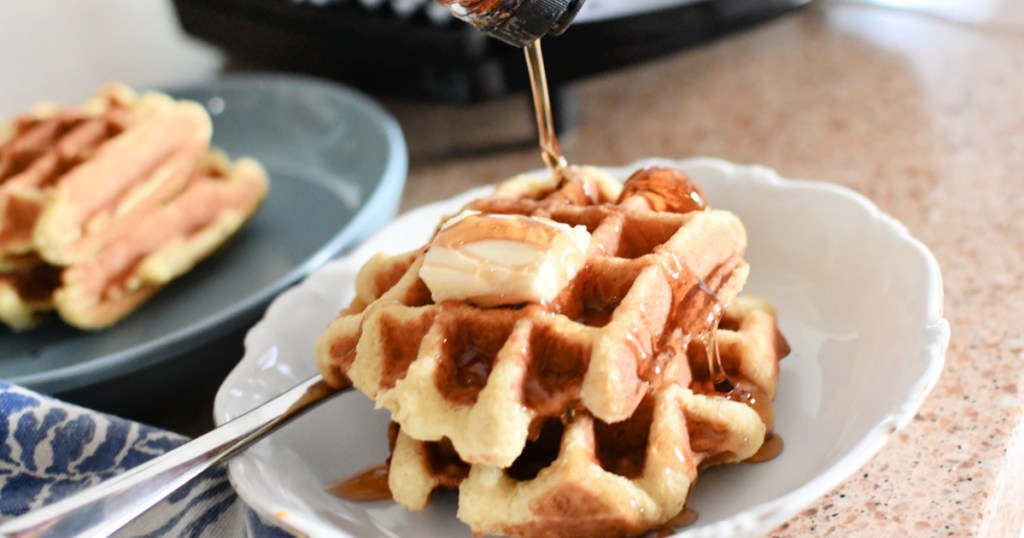 pouring syrup on keto waffles