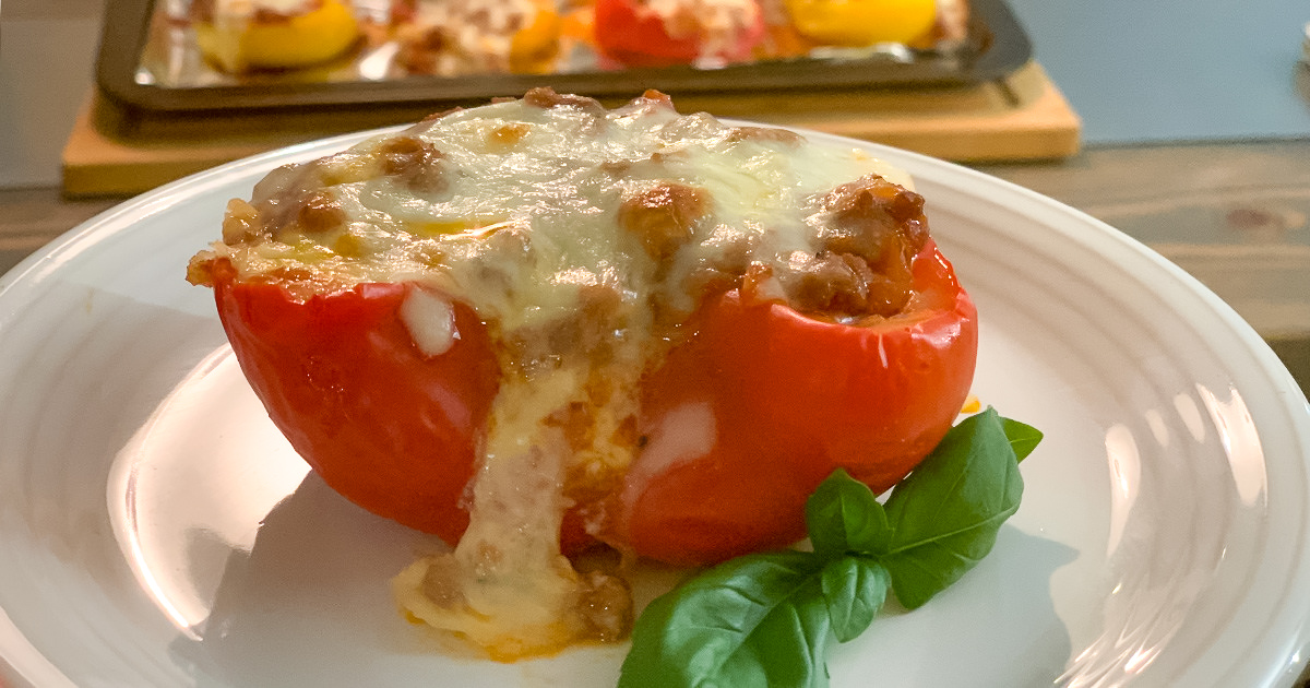 low-carb stuffed lasagna bell pepper boats on a plate with garnish