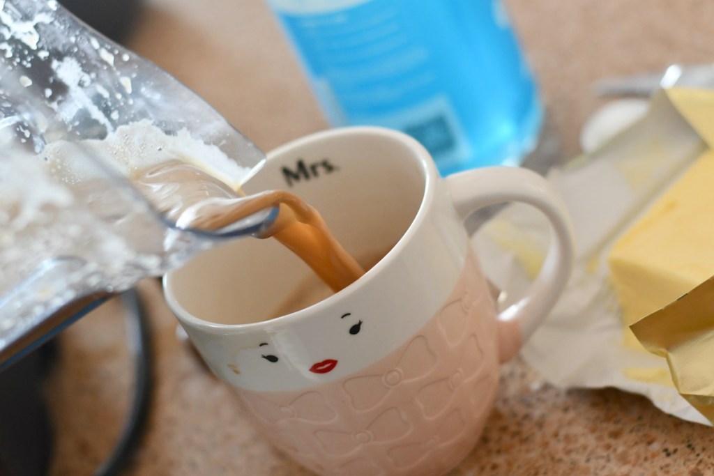 pouring bulletproof coffee into mug 