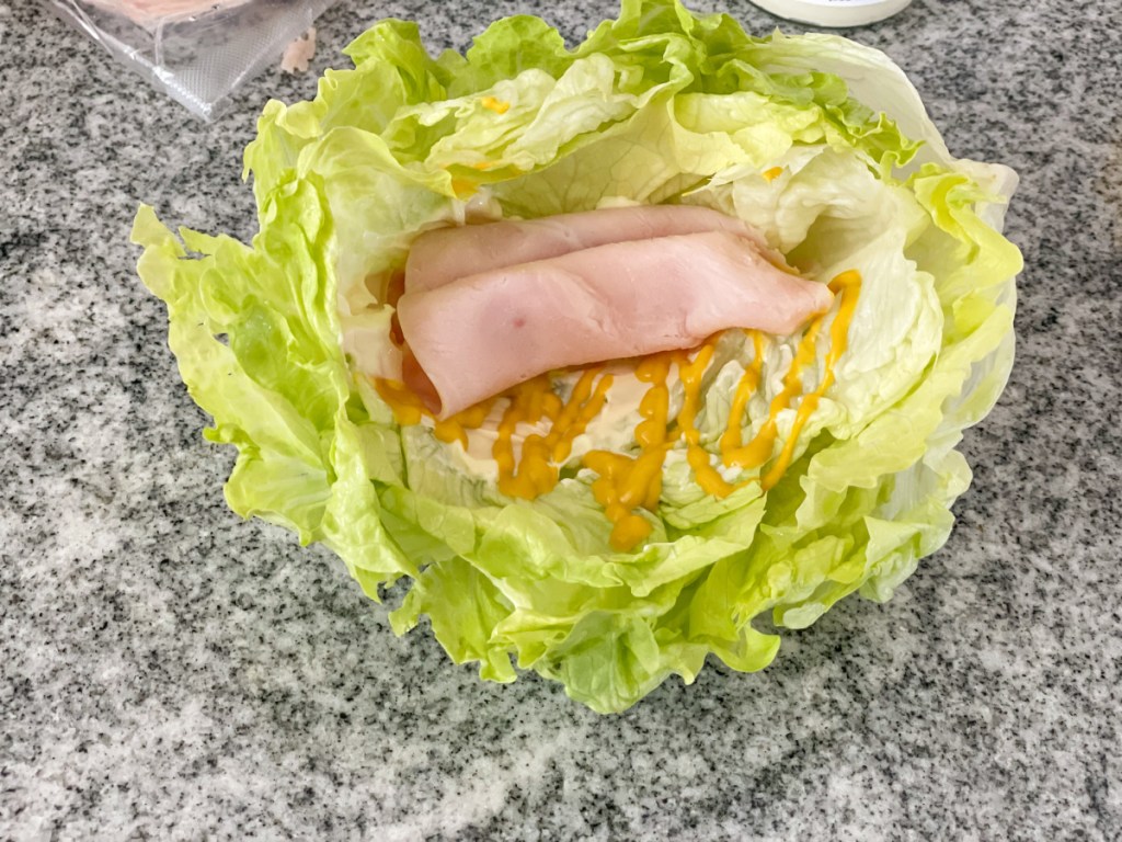 iceberg lettuce bowl with mayo, mustard, and turkey lunch meat