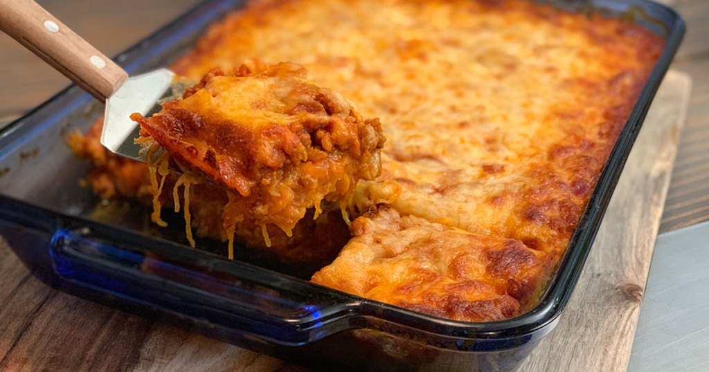 Keto Italian Sausage and Spaghetti Squash Casserole - large serving of casserole being scooped out of hot pan