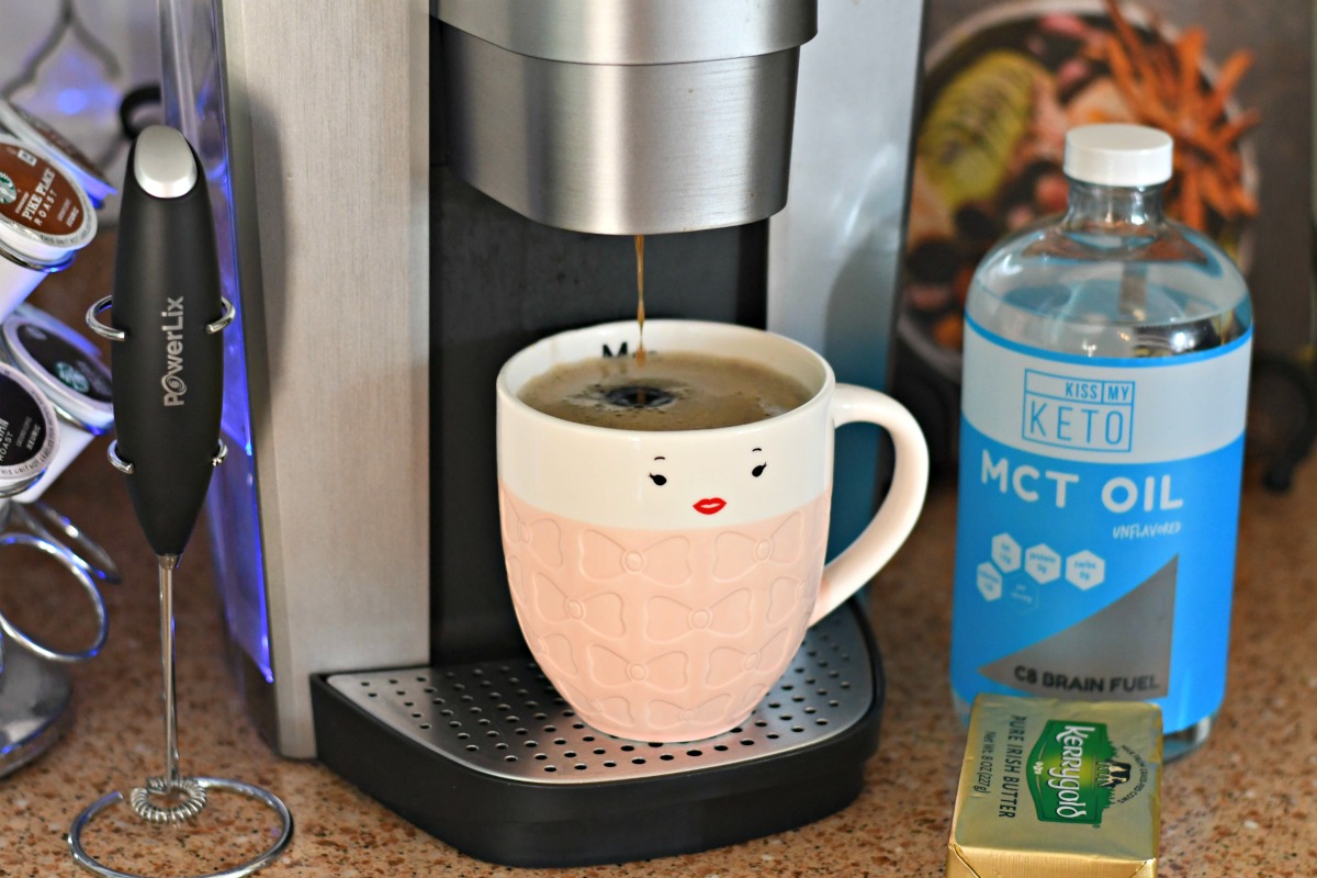 bulletproof coffee keto drink – mug of coffee being brewed into a cup