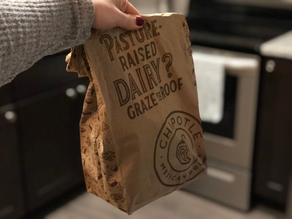 holding Chipotle delivery bag in kitchen 