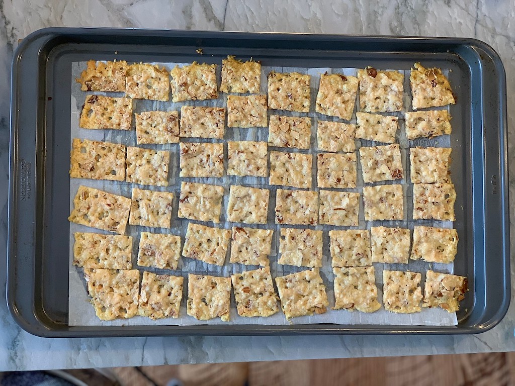 baked keto cheese crackers on parchment lined pan