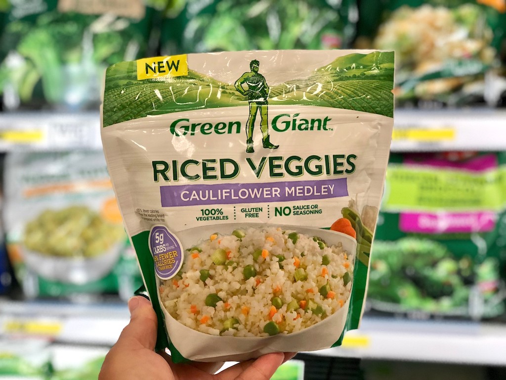 holding bag of Green Giant riced veggies at Target 