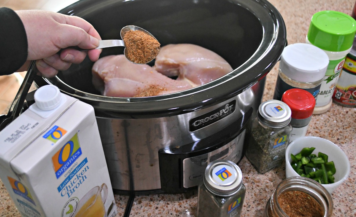 keto slow cooker shredded chicken tacos going into the slow cooker