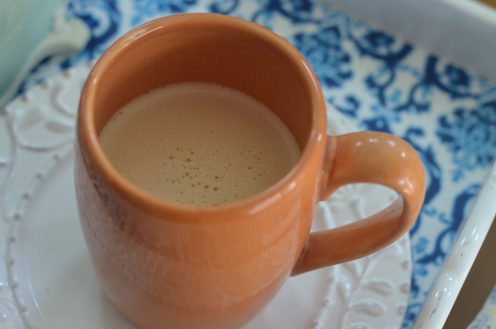 latte in orange coffee cup