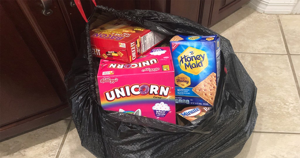 garbage bag filled with cereal, crackers, and other non-keo food