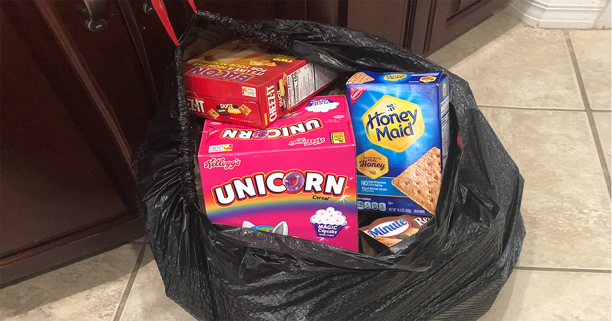 garbage bag filled with cereal, crackers, and other non-keto food