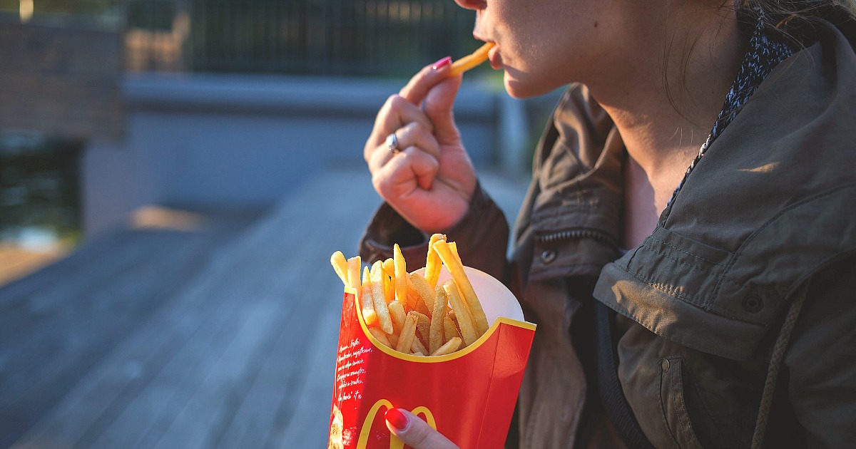woman eating mcdonald's french fries
