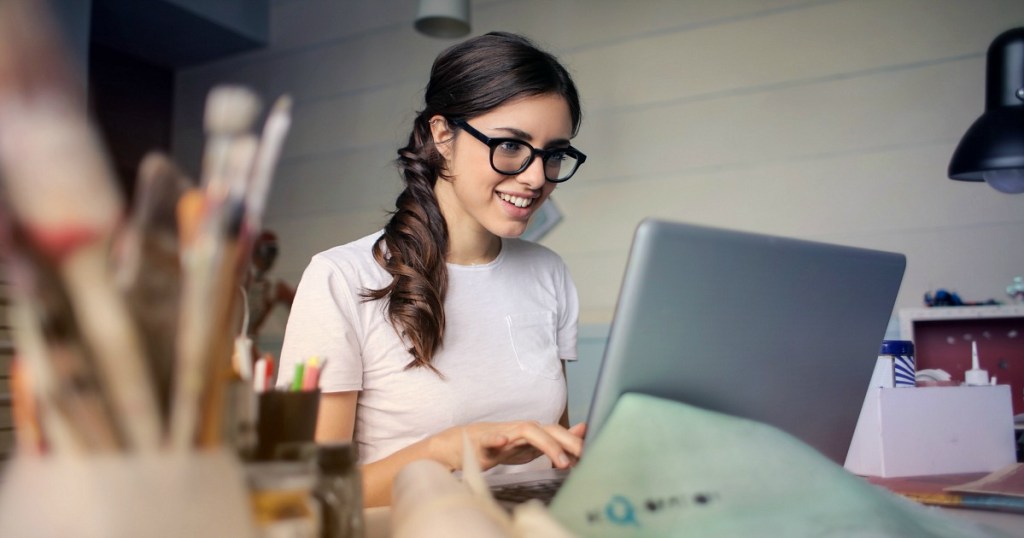 woman wearing glasses sitting focused at computer 