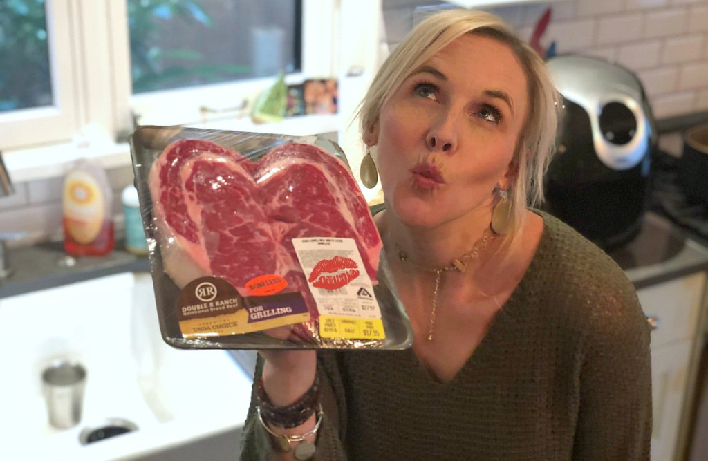 woman holding heart-shaped Steak