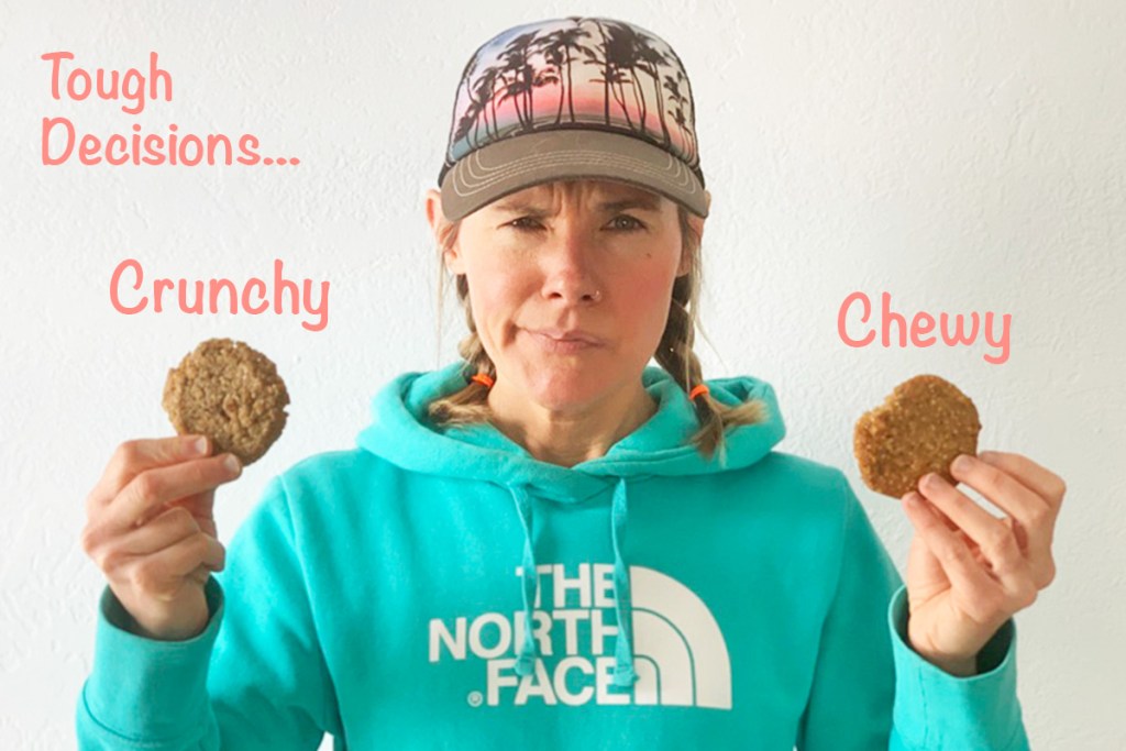 A woman holding two cookies, one crunchy and one chewy