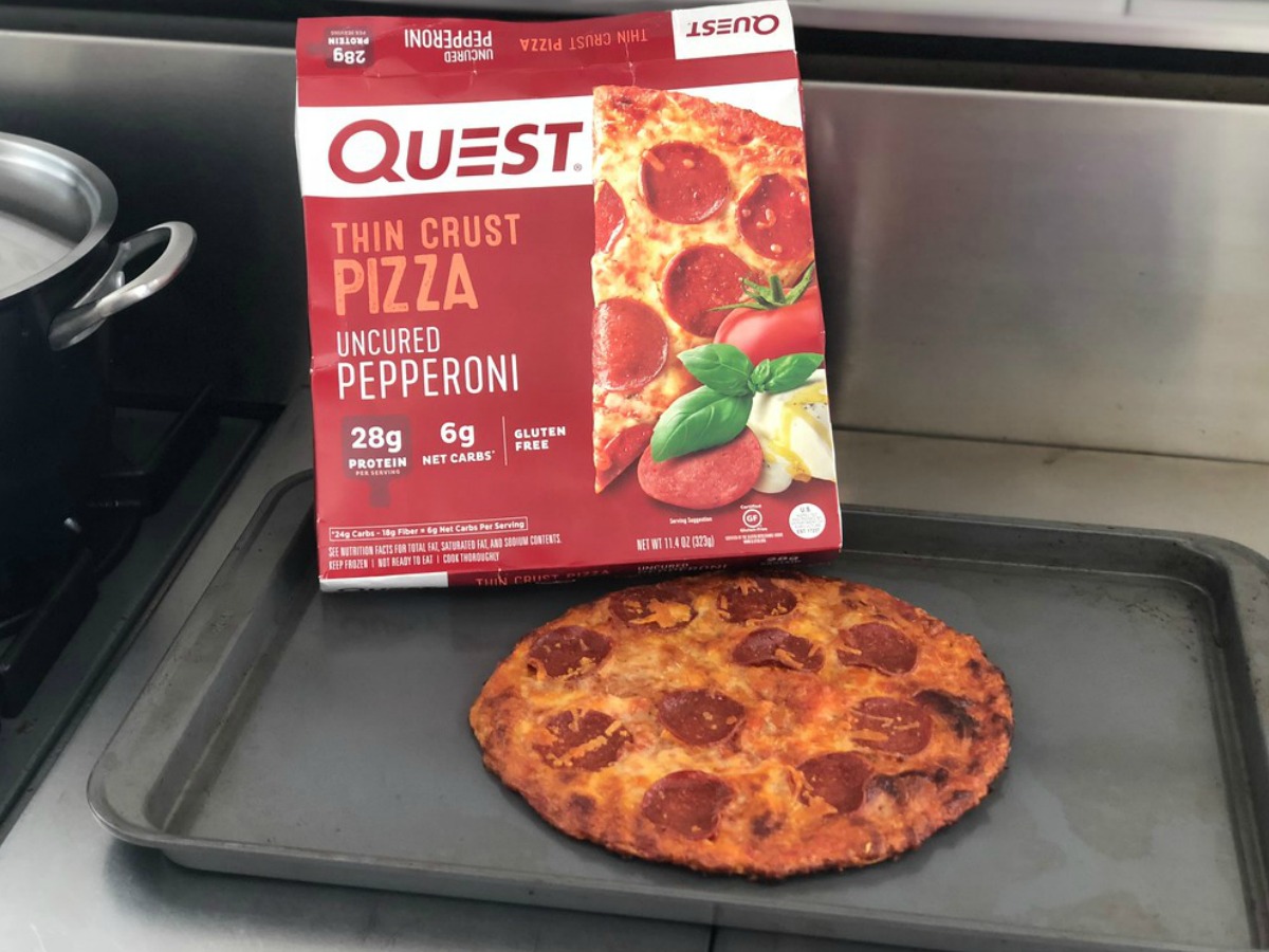 Quest pizza box next to a cooked pizza