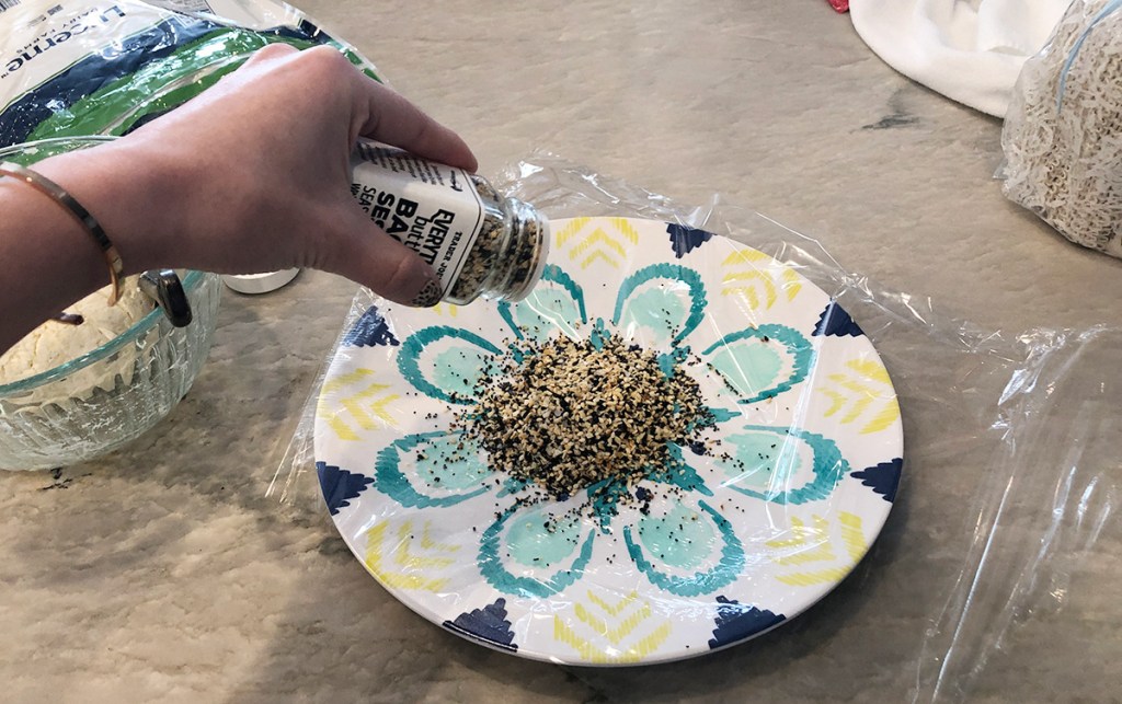 pouring everything but the bagel seasoning onto a plate