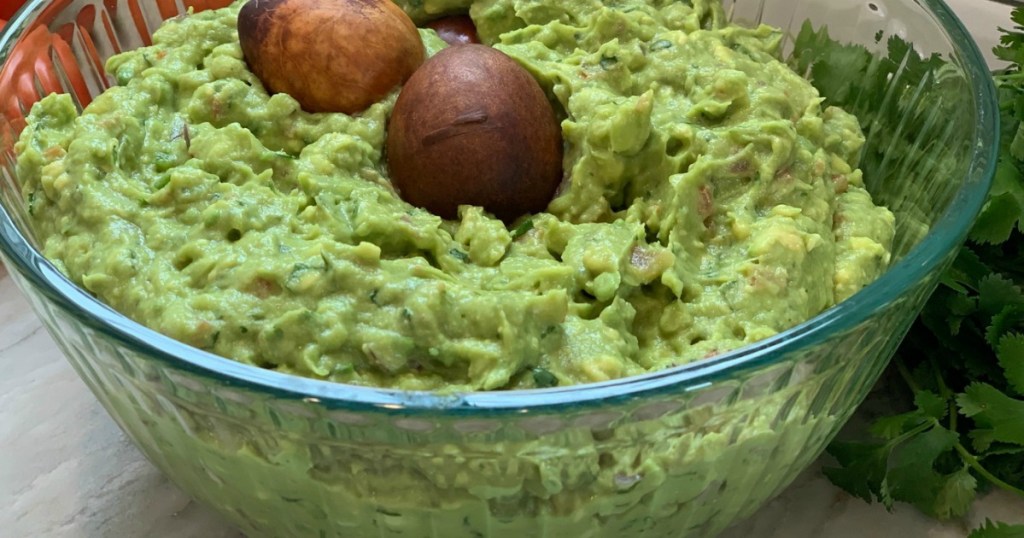 large bowl filled with fresh guacamole 