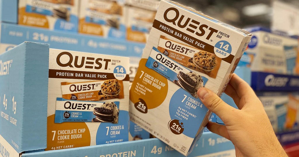 hand holding quest bars at sams club