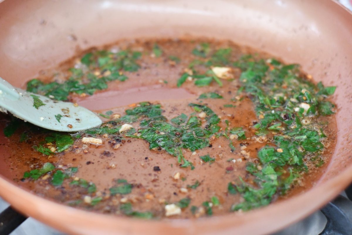 lightly cooking herbs in the butter in a pan