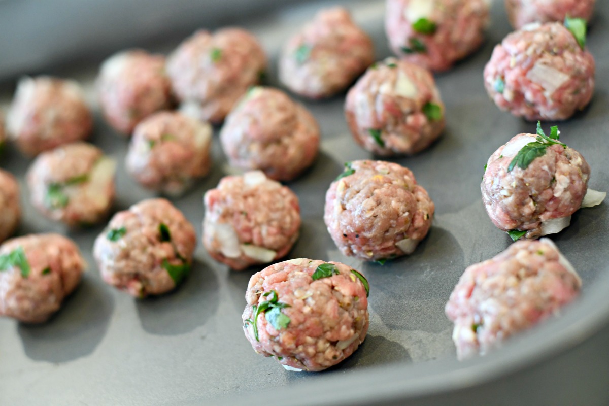 meatballs rolled out on a baking pan