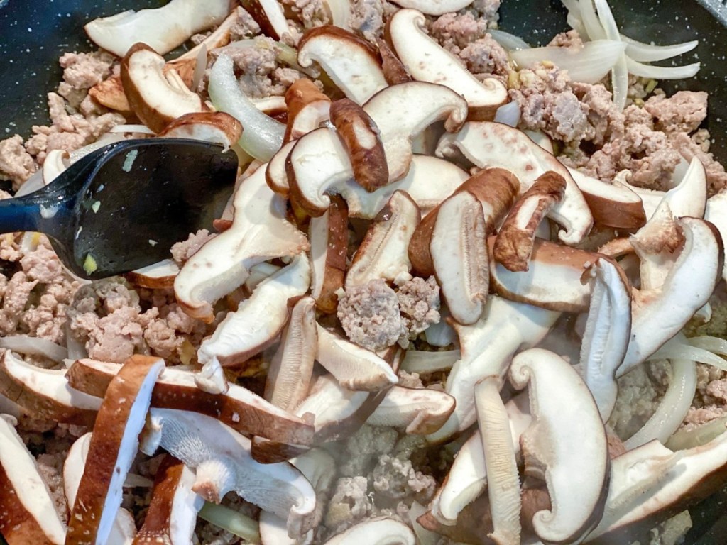mushrooms, ground meat, and onions in skillet