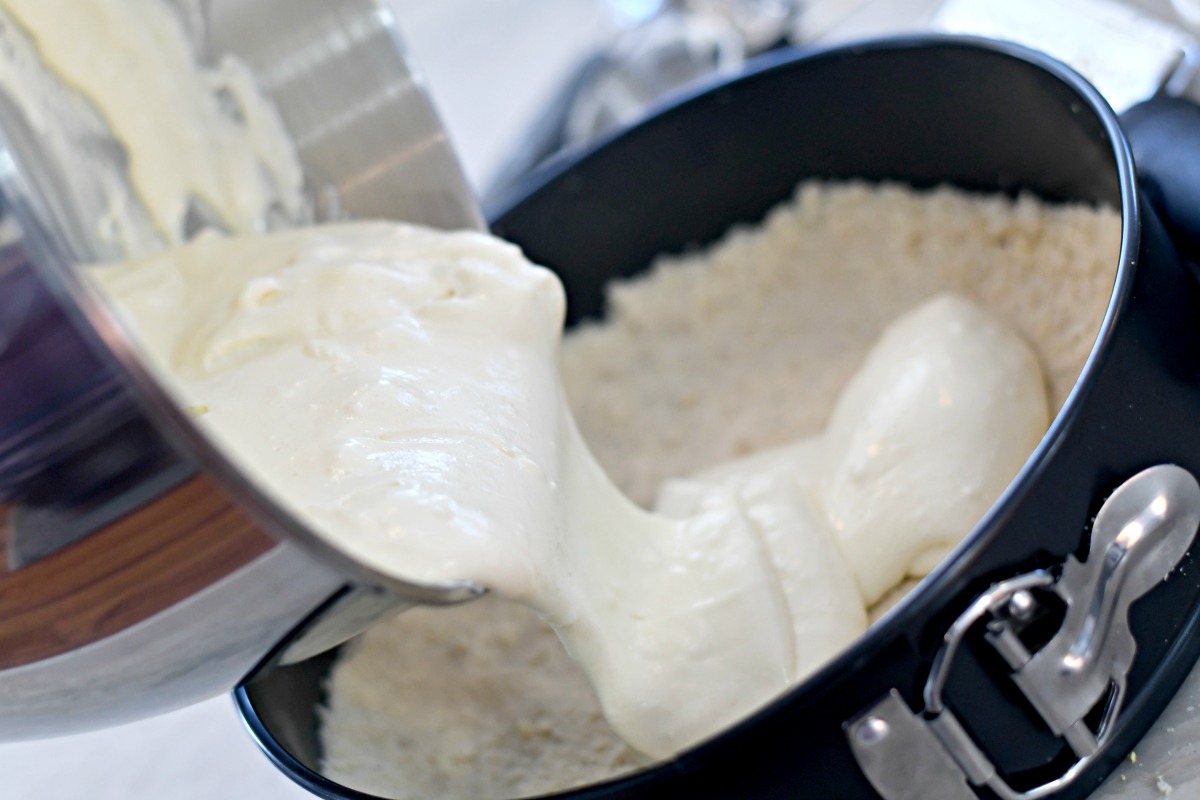 pouring the sugar-free cheesecake batter into a springform pan