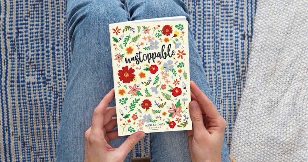 holding journal that has the word unstoppable 