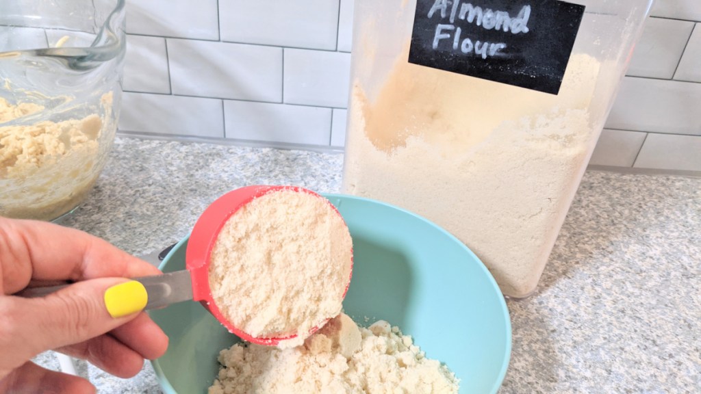adding almond flour to bowl