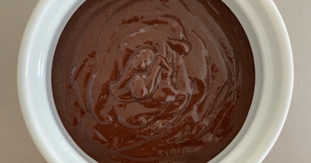 A ramekin with chocolate cake batter awaiting the microwave