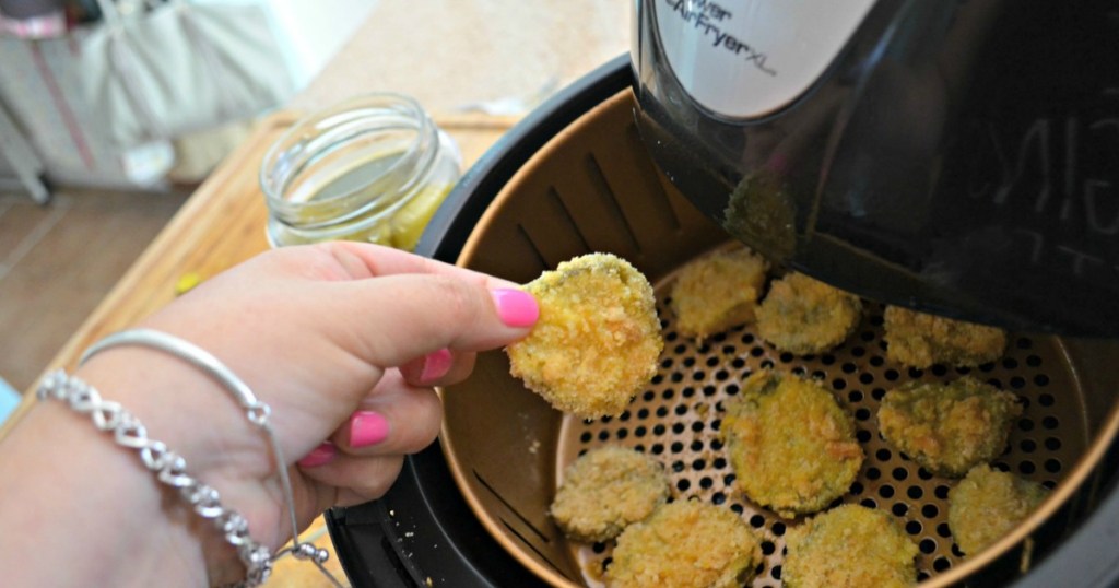 holding a crunchy air fryer fried pickle