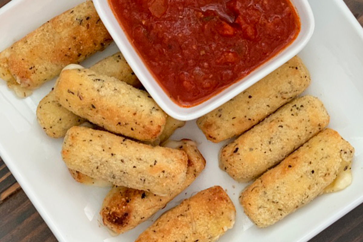 A plate with keto air fryer mozzarella stick and marina sauce