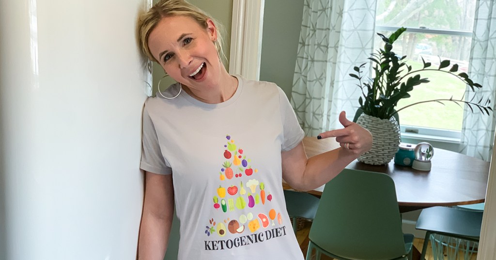 woman wearing t-shirt with keto diet pyramid graphic on front