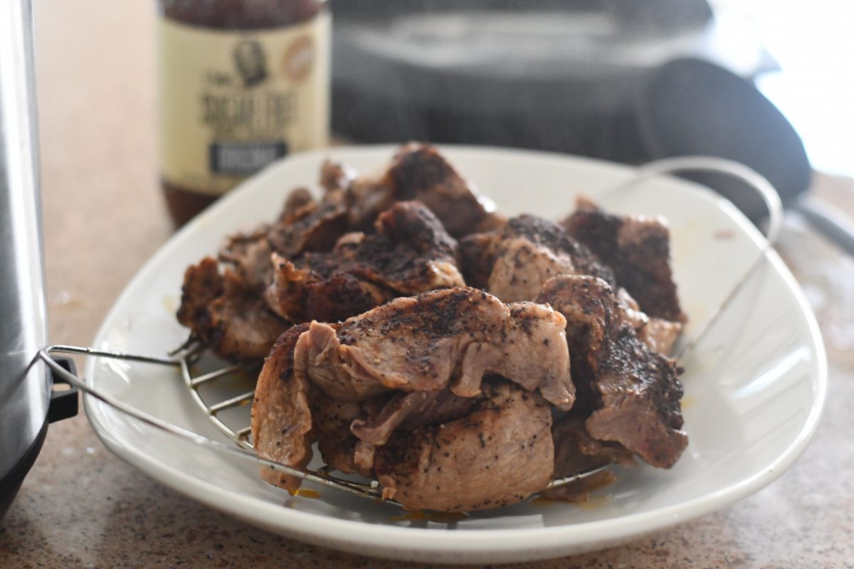 cooked bbq pork on a plate after cooking in the instant pot