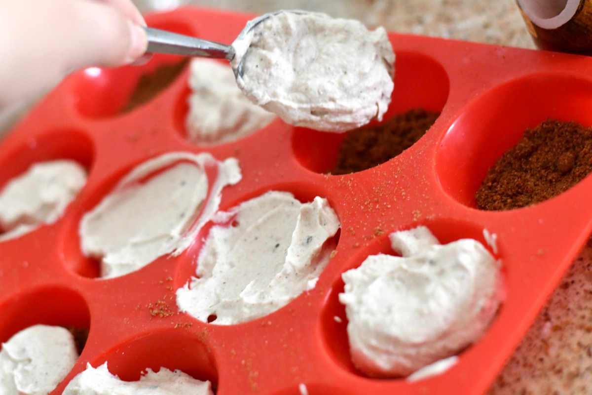 adding the filling to the Cookies and Cream Keto Fat Bombs