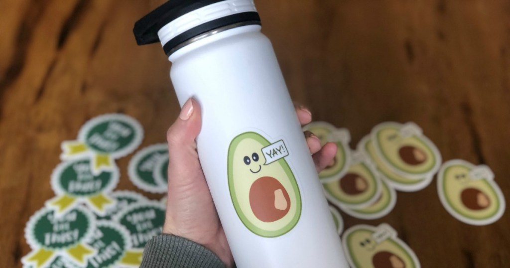 holding avocado water bottle 