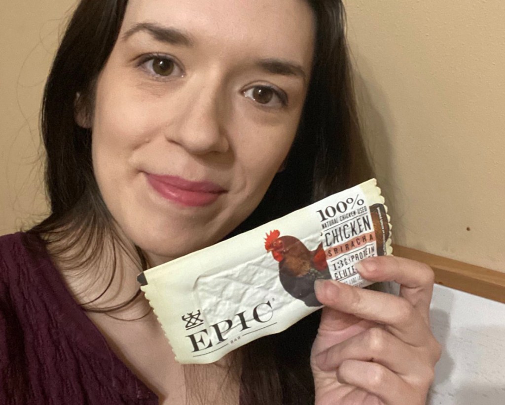 woman holding epic protein bar