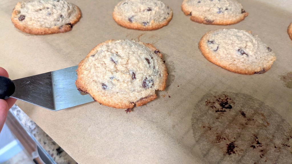 taking chocolate chip cookie off pan 